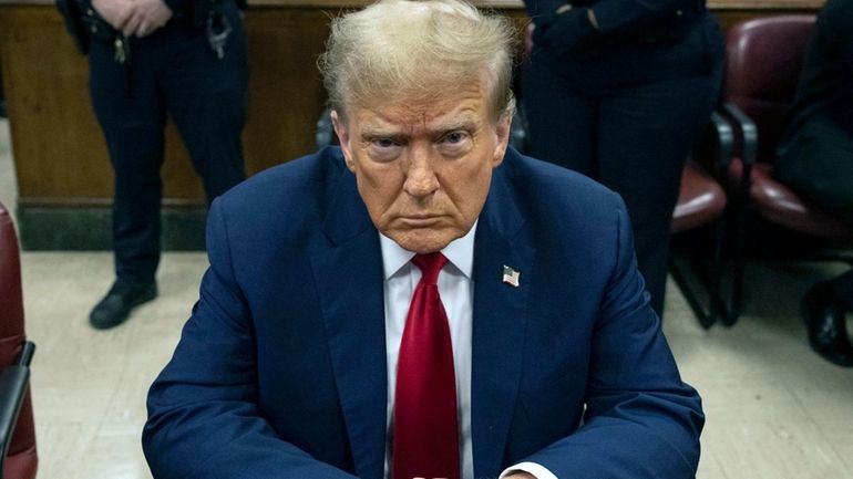 Donald Trump waits for the start of proceedings during his...