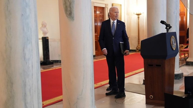 President Joe Biden walks away from the podium after speaking...