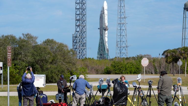 Photographers reset their remote cameras for yet another launch attempt...