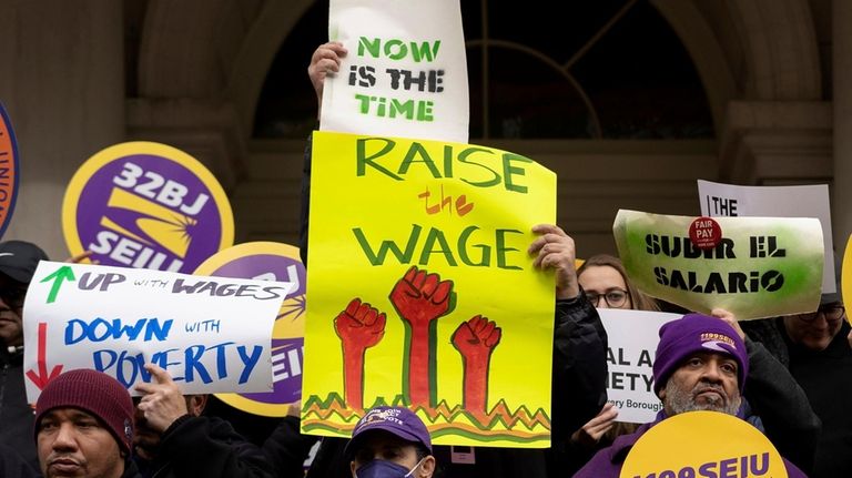 Union members rally at City Hall in New York City...