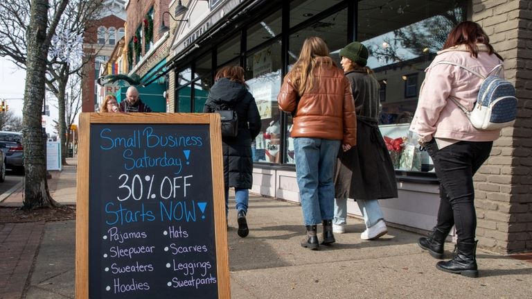 Shoppers walk along Main Street in Patchogue during Small Business...