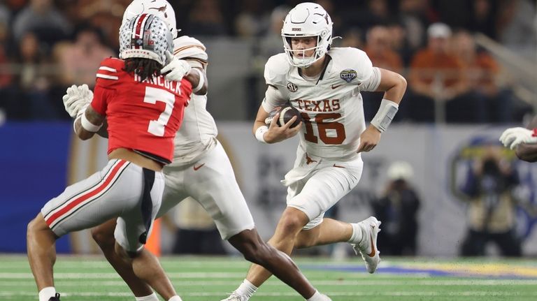 Texas quarterback Arch Manning (16) runs against Ohio State during...