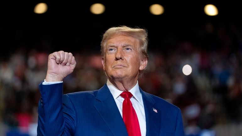 Republican presidential nominee former President Donald Trump pumps his fist...