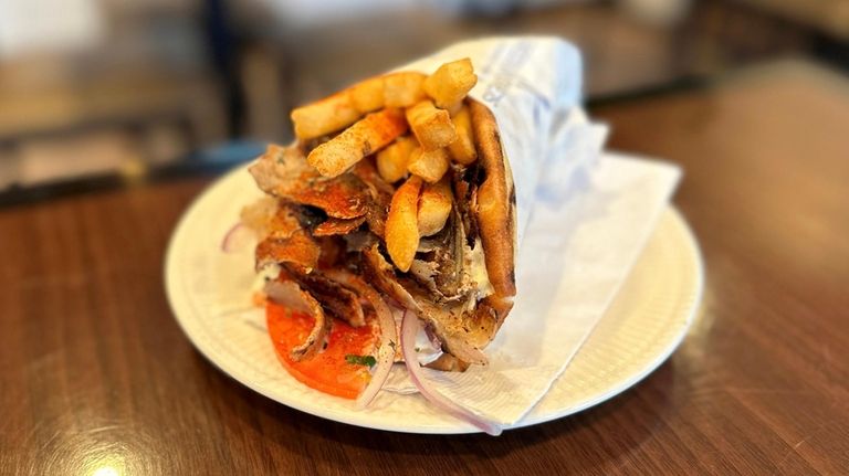 An authentic Greek gyro, with pork and French fries, at...