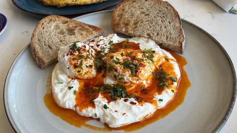 Cilbir is a Turkish egg dish with Greek yogurt and...