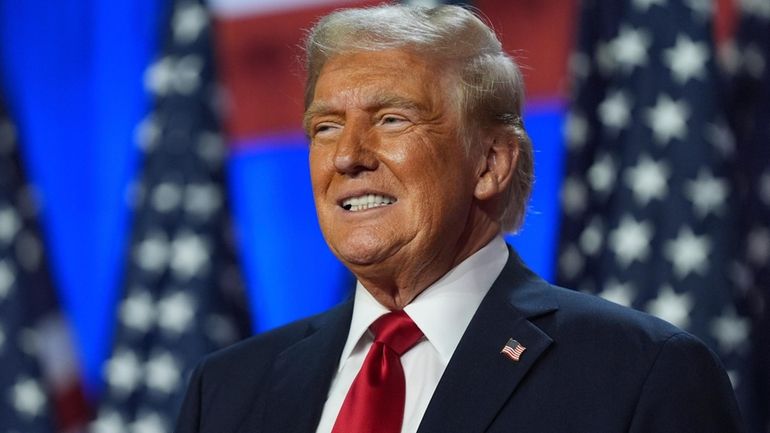 Republican presidential nominee former President Donald Trump smiles at an...