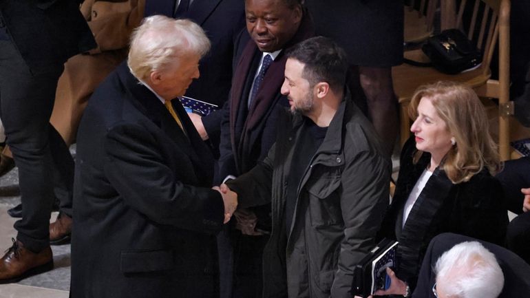 President-elect Donald Trump shakes hands with Ukraine's President Volodymyr Zelenskyy...