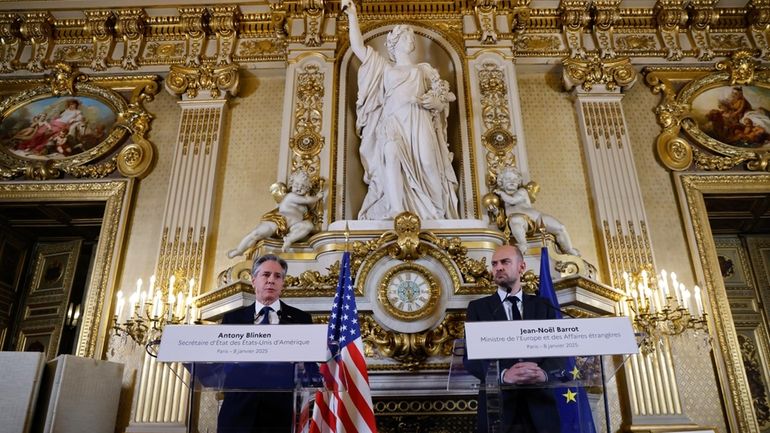 US Secretary of State Antony Blinken, left, addresses the media...