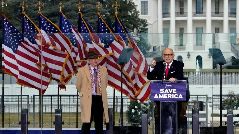 Chapman University law professor John Eastman stands at left as...