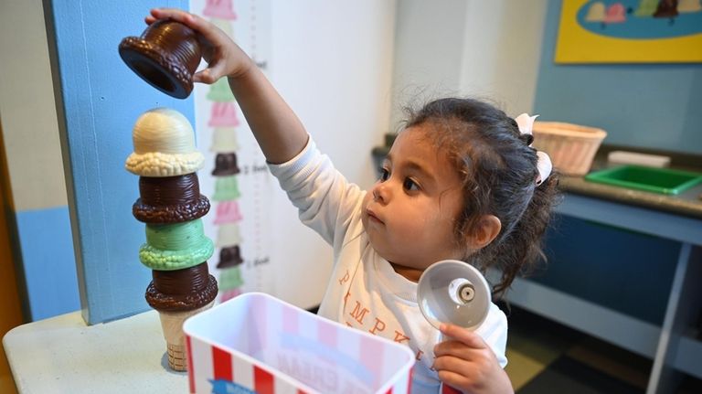 Arianna Katz, 2, of Little Neck, plays in the Tot...