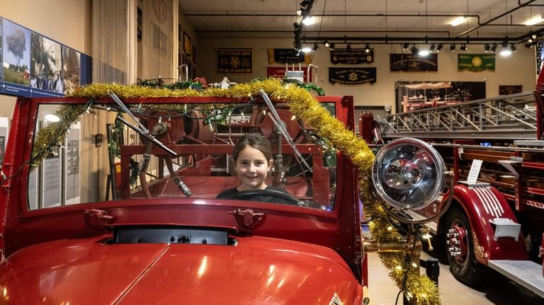 Amelia Canzoneri, 6, takes the driver's seat at the Nassau County...