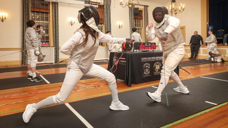 Fencers Paulina Pawlak and Nick Bridges, both of Sayville, compete...