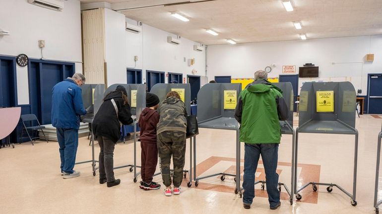 Voters at the Jamaica Avenue polling site in Plainview cast...