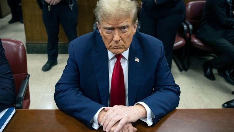 Then-former President Donald Trump waits for the start of proceedings...