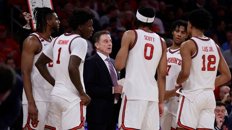 St. John's head coach Rick Pitino talks to his team...