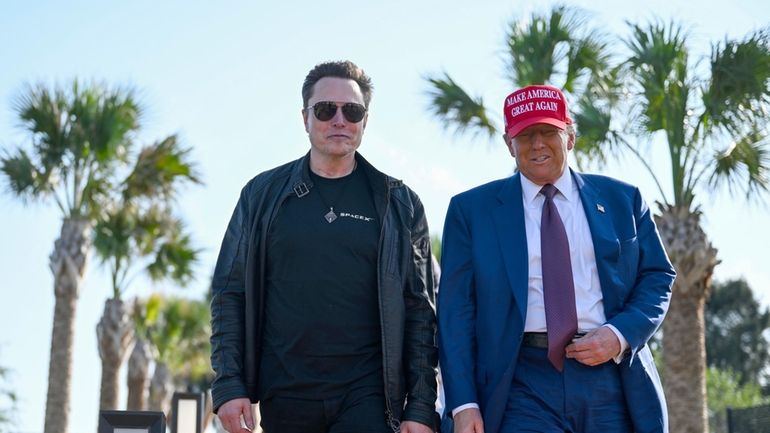 President-elect Donald Trump walks with Elon Musk before the launch...