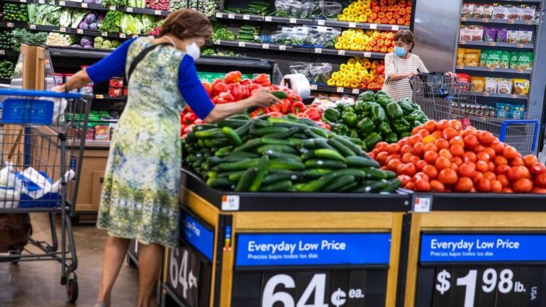 People buy groceries at a Walmart Superstore in Secaucus, New...