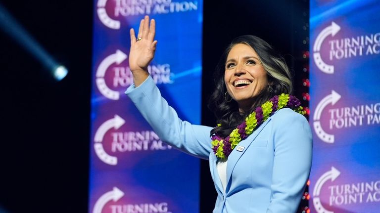 Former Democratic Rep. Tulsi Gabbard waves as she arrives to...