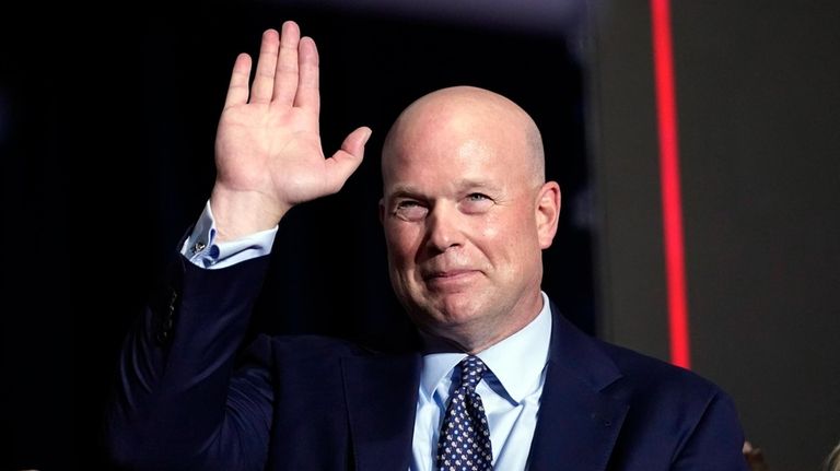 Former acting Attorney General Matt Whitaker waves at a caucus...