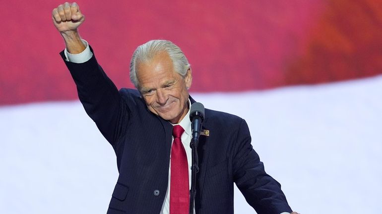 Peter Navarro raises his fist while speaking during the Republican...