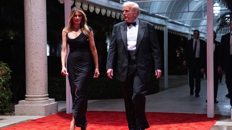 Melania Trump looks on as President-elect Donald Trump arrives for...