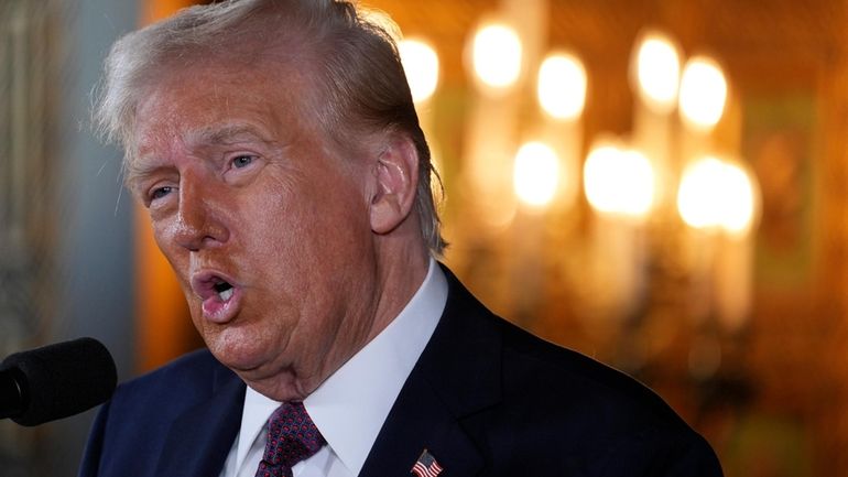 President-elect Donald Trump speaks during a news conference at Mar-a-Lago...