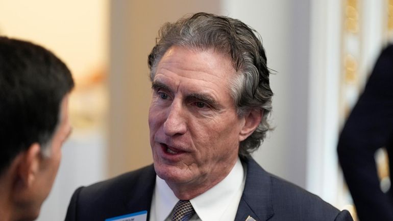 Gov. Doug Burgum, R-N.D., chats at the New York Stock...