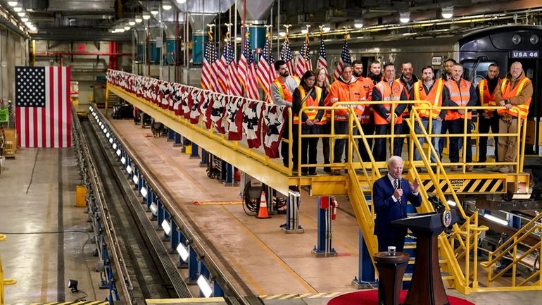 President Joe Biden speaks at the construction site of the...